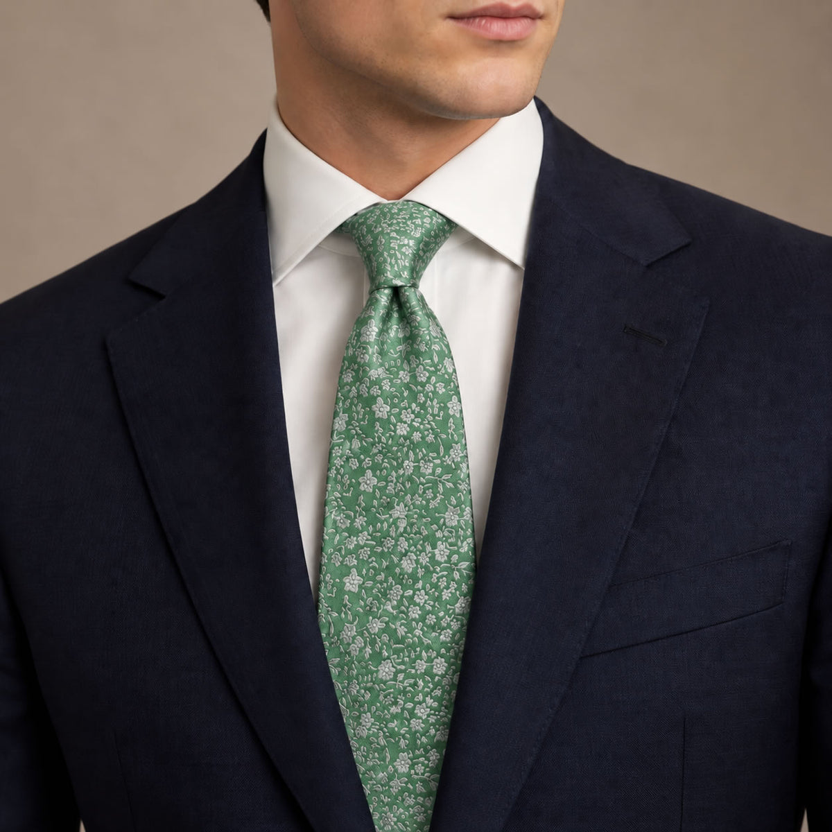 Sage Green Floral Silk Tie by George Neale, worn by a model with a suit and shirt