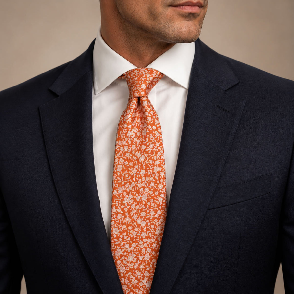 Orange Floral Silk Tie by George Neale, worn by a model with a suit and shirt