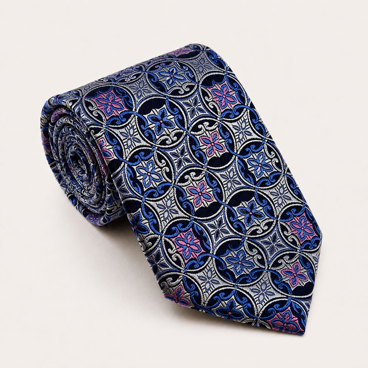 A rolled George Neale silver and blue patterned silk tie.