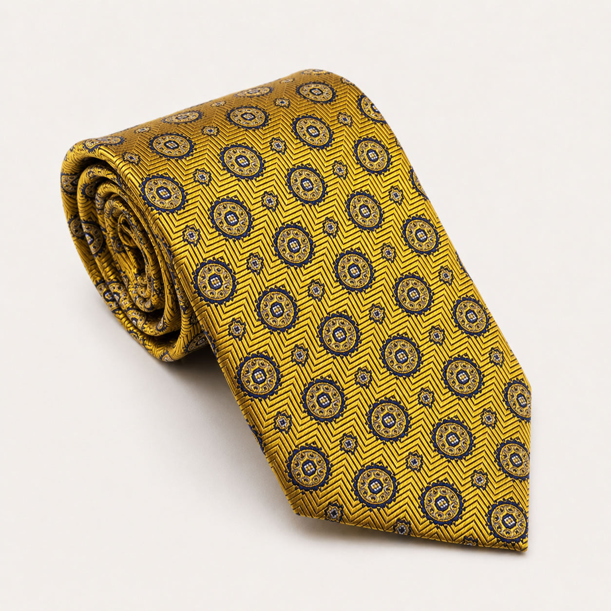 A rolled George Neale yellow and navy patterned silk tie.