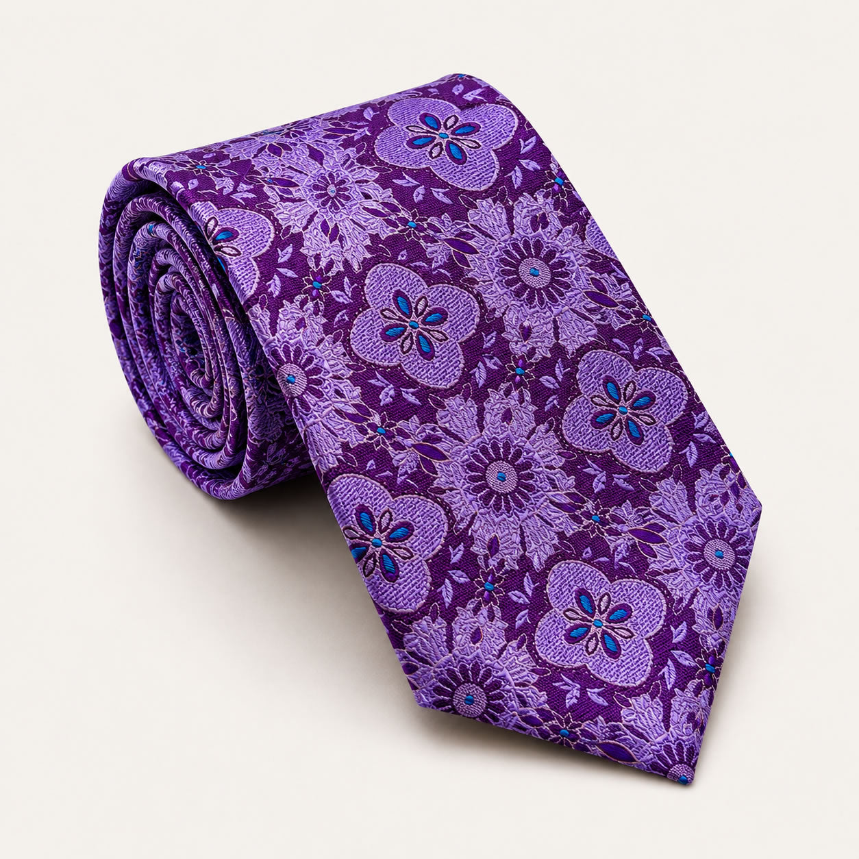A rolled George Neale purple patterned silk tie.