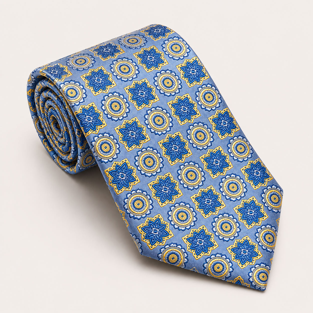 A rolled George Neale sky blue and yellow patterned silk tie.