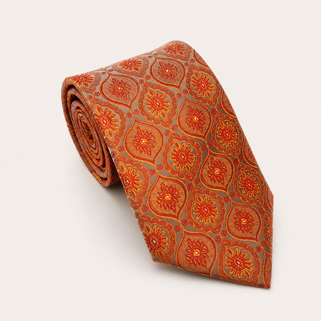 A rolled George Neale burnt orange and grey patterned silk tie.