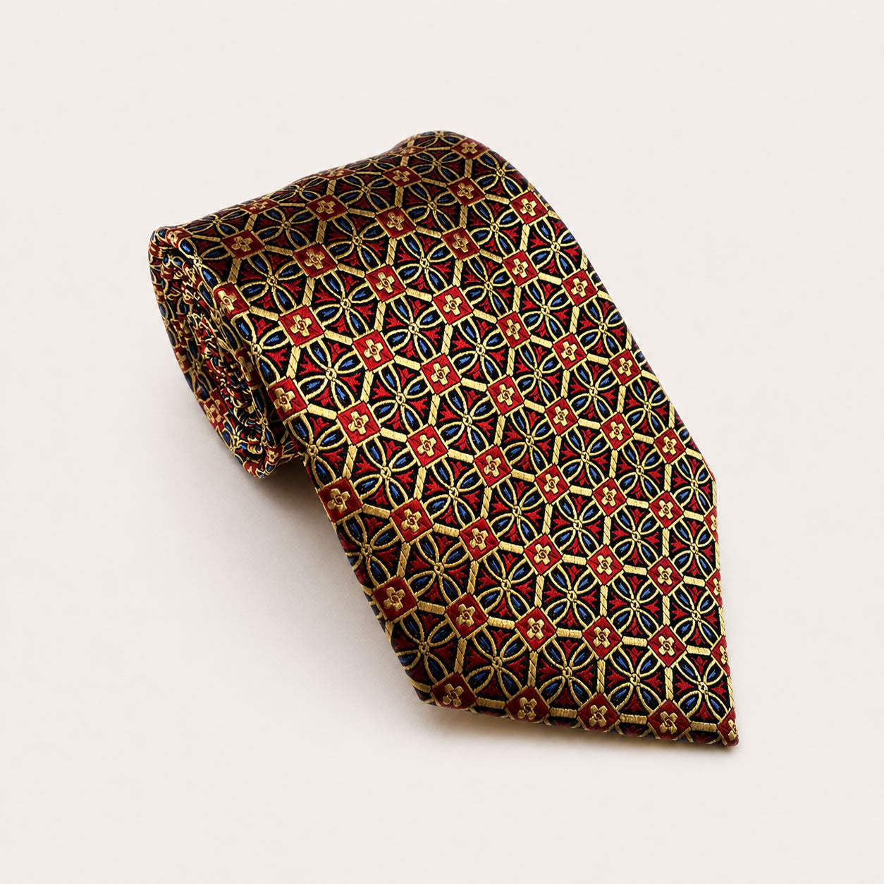 A rolled George Neale red and gold patterned silk tie.