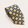 A rolled George Neale navy and champagne patterned silk tie.