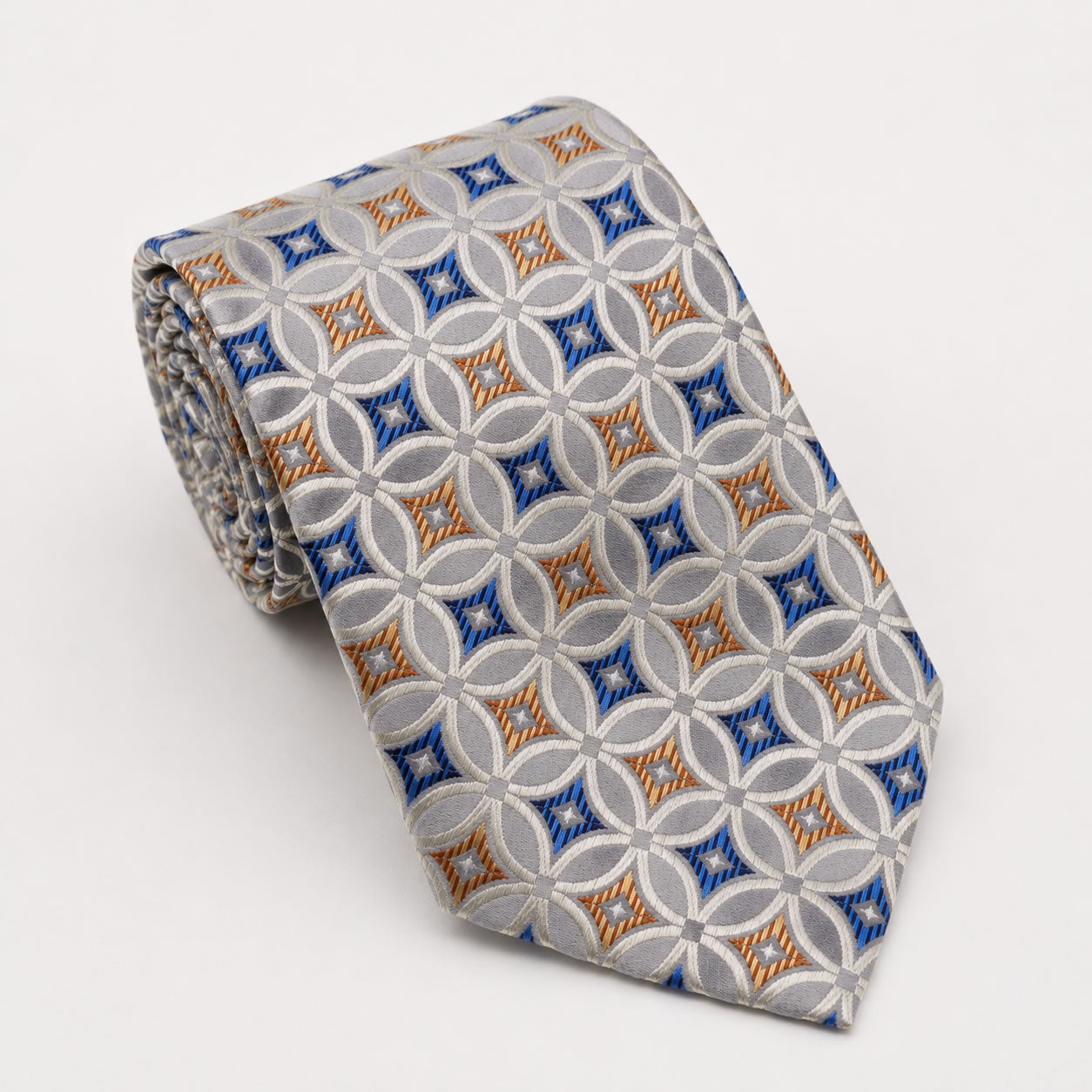 A rolled George Neale silver and blue patterned silk tie.