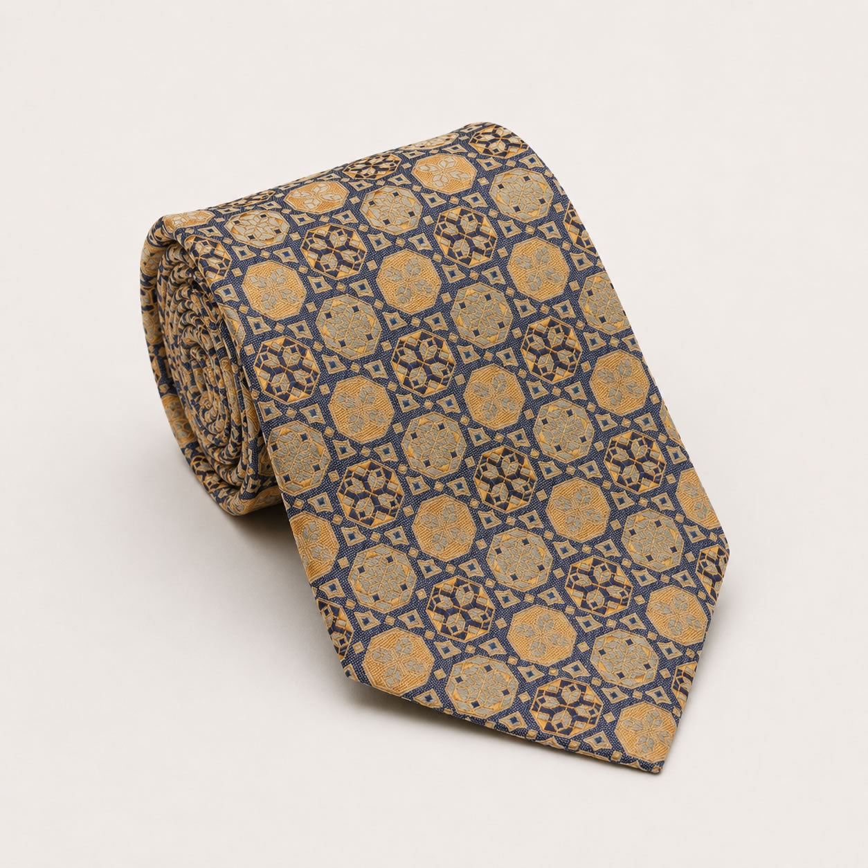 A rolled George Neale navy and gold patterned silk tie.