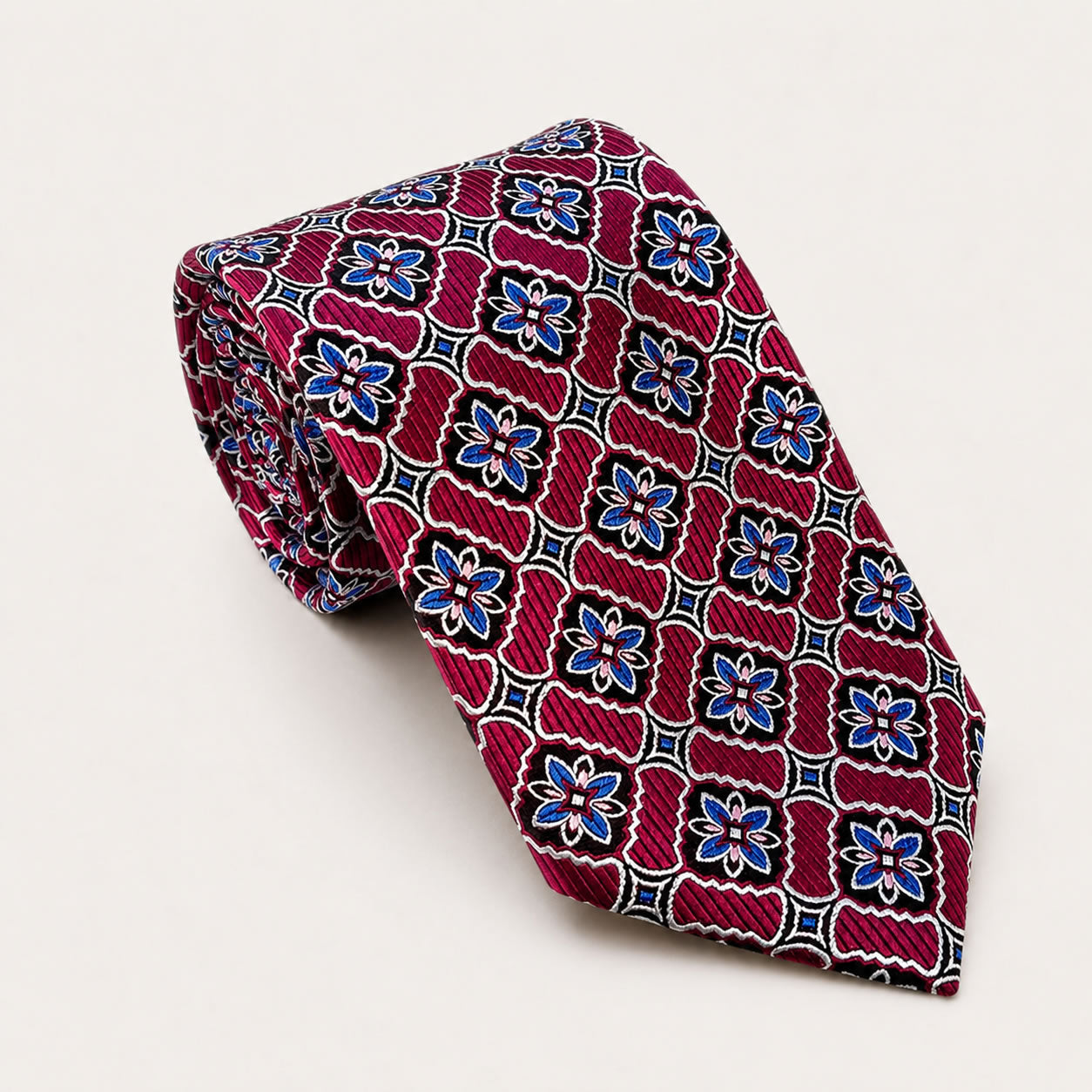 A rolled George Neale fuchsia and blue patterned silk tie.