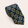 A rolled George Neale blue and green patterned silk tie.