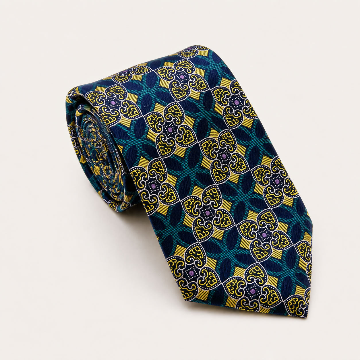 A rolled George Neale blue and green patterned silk tie.