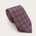 A rolled George Neale pink patterned silk tie.