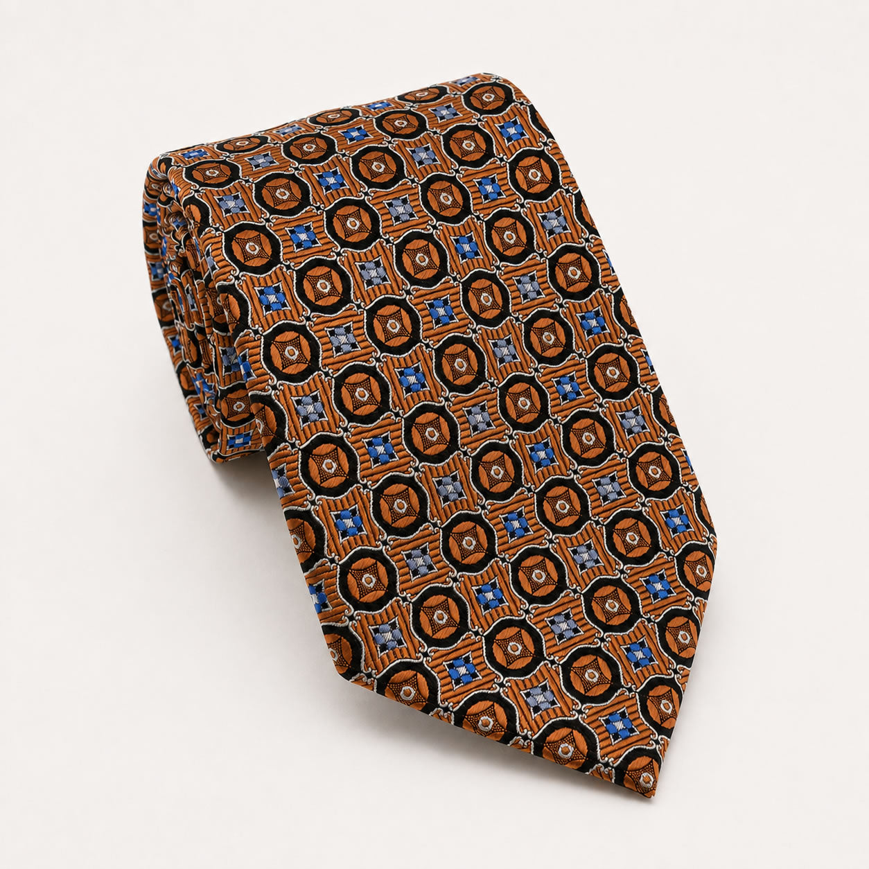 A rolled George Neale brown and blue patterned silk tie.
