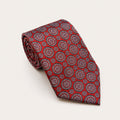 A rolled George Neale red patterned silk tie.