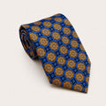 A rolled George Neale blue and gold patterned silk tie.