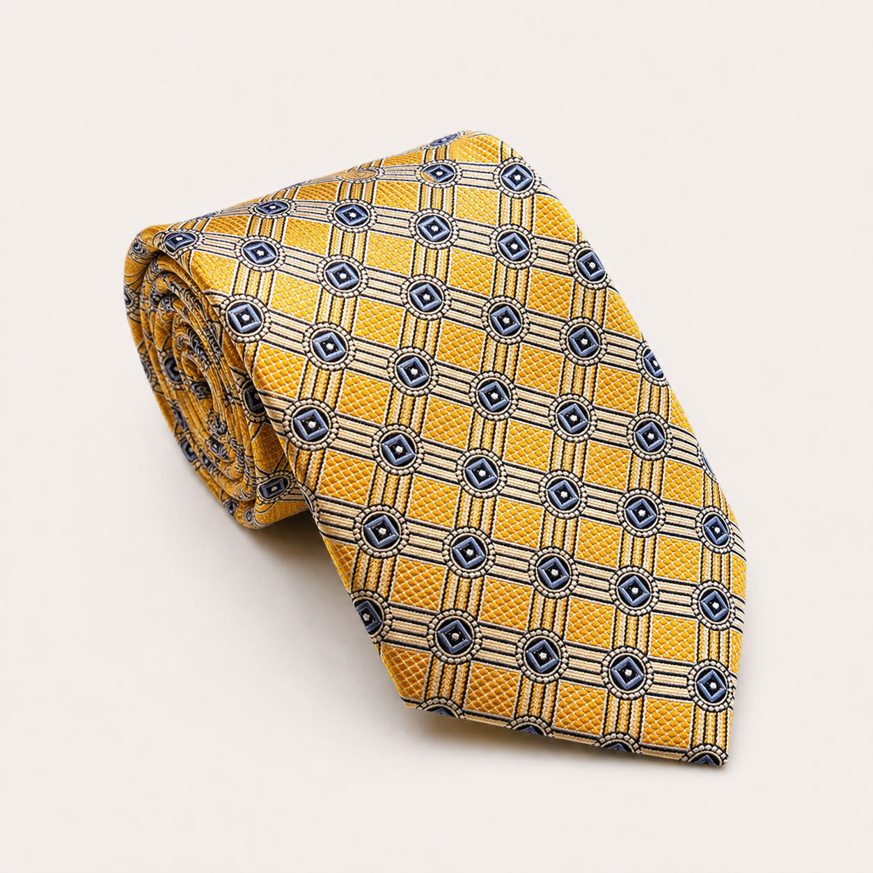 A rolled George Neale yellow and blue patterned silk tie.