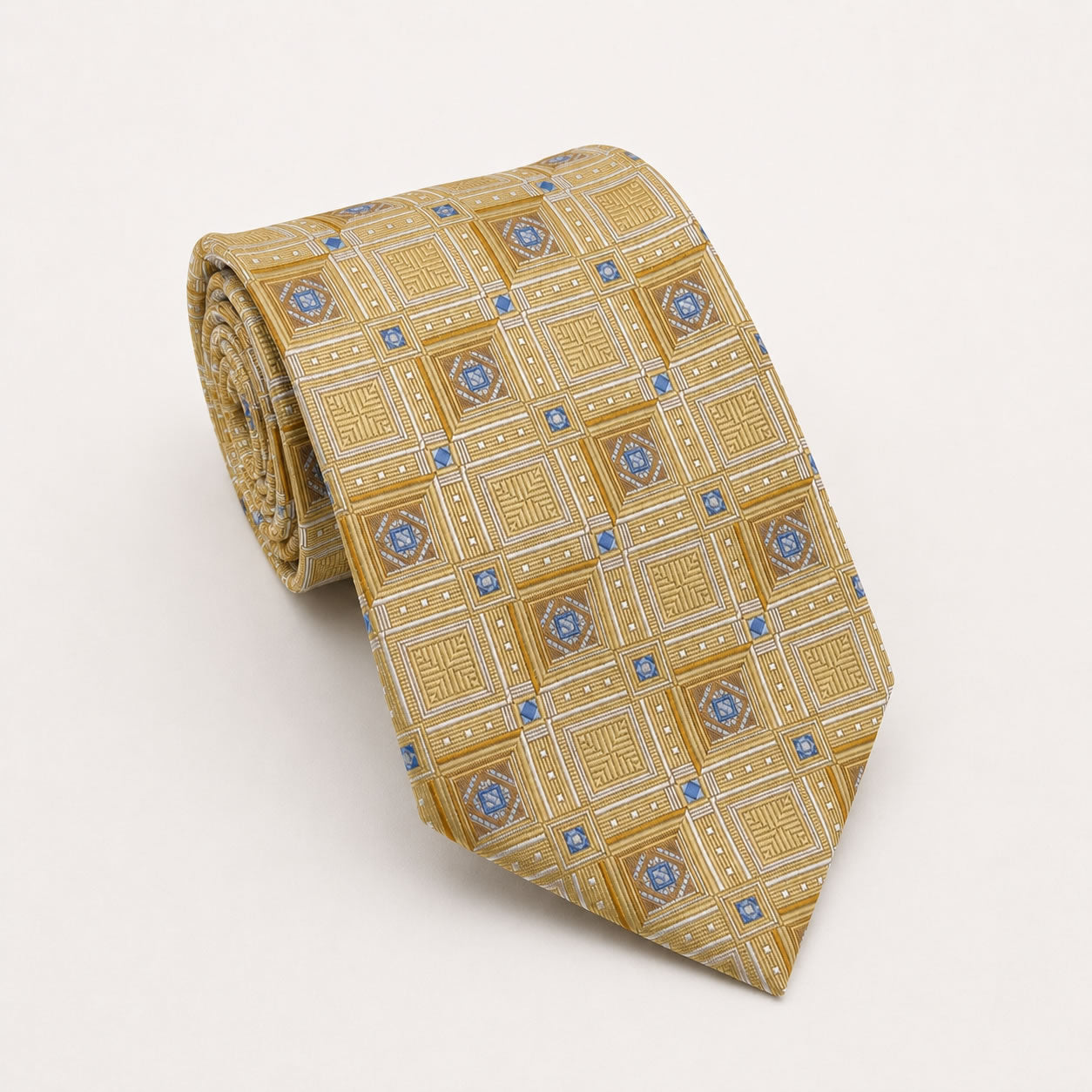 A rolled George Neale gold and blue patterned silk tie.