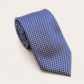 A rolled George Neale blue and cream patterned silk tie.