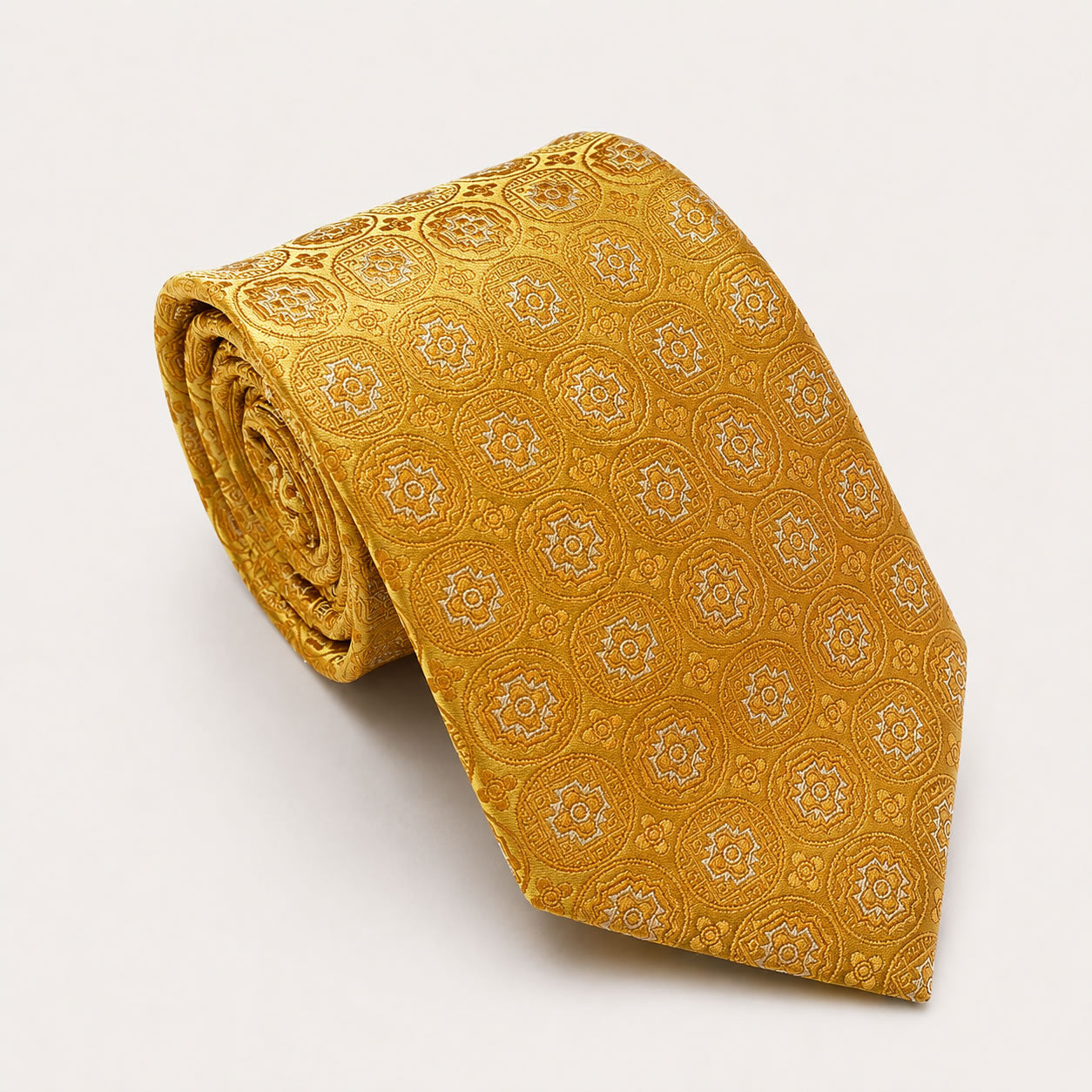 A rolled George Neale gold patterned silk tie.
