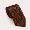 A rolled George Neale copper and black patterned silk tie.
