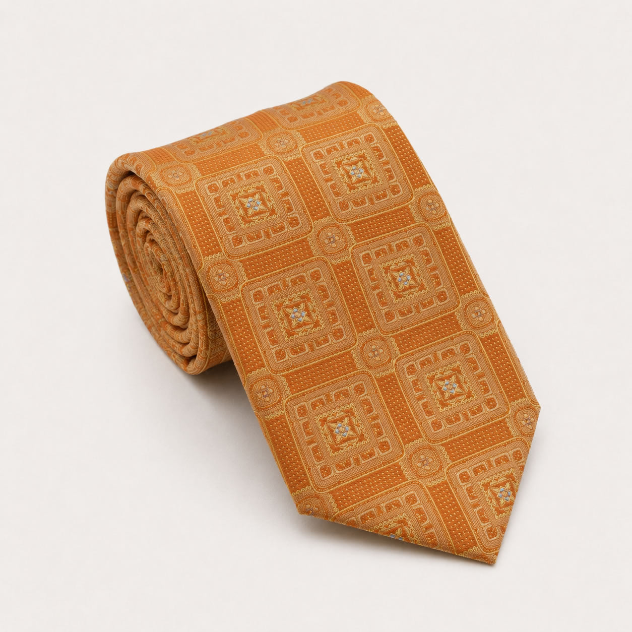 A rolled George Neale amber patterned silk tie.