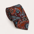 A rolled George Neale burnt orange and light blue paisley silk tie.