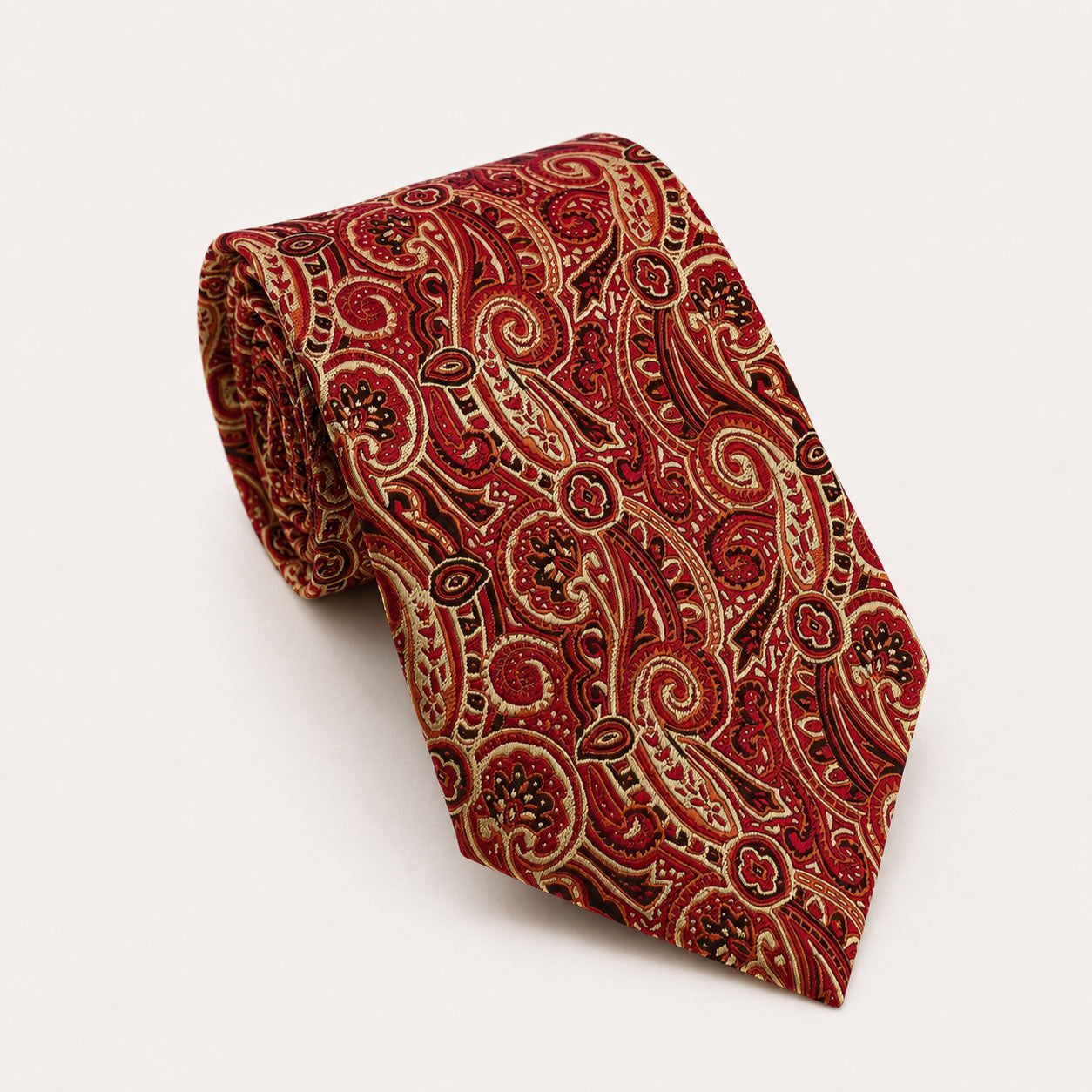 A rolled George Neale red and gold paisley silk tie.