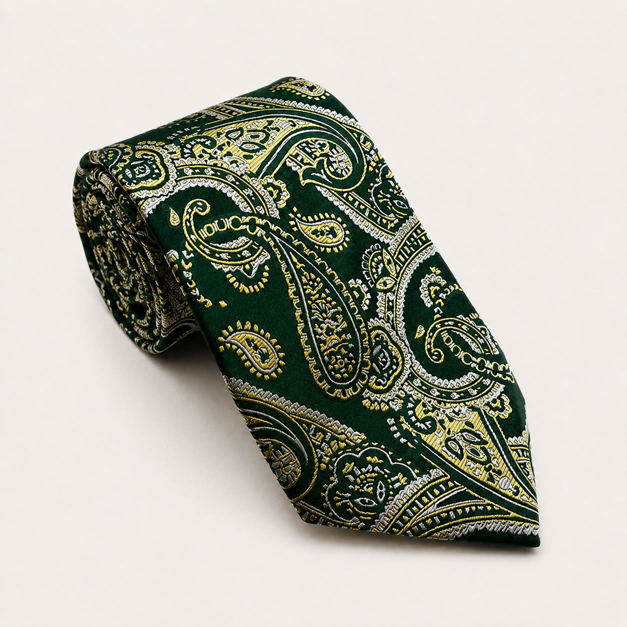 A rolled George Neale forest green and gold paisley silk tie.