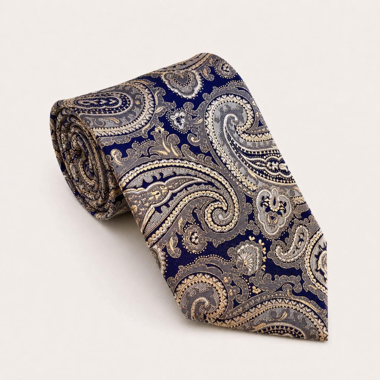 A rolled George Neale navy and champagne paisley silk tie.