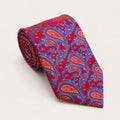 A rolled George Neale red and purple paisley silk tie.