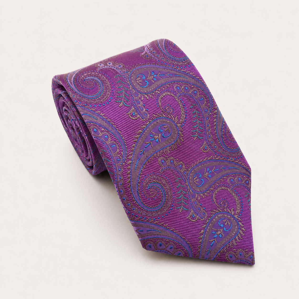 A rolled George Neale purple and blue paisley silk tie.