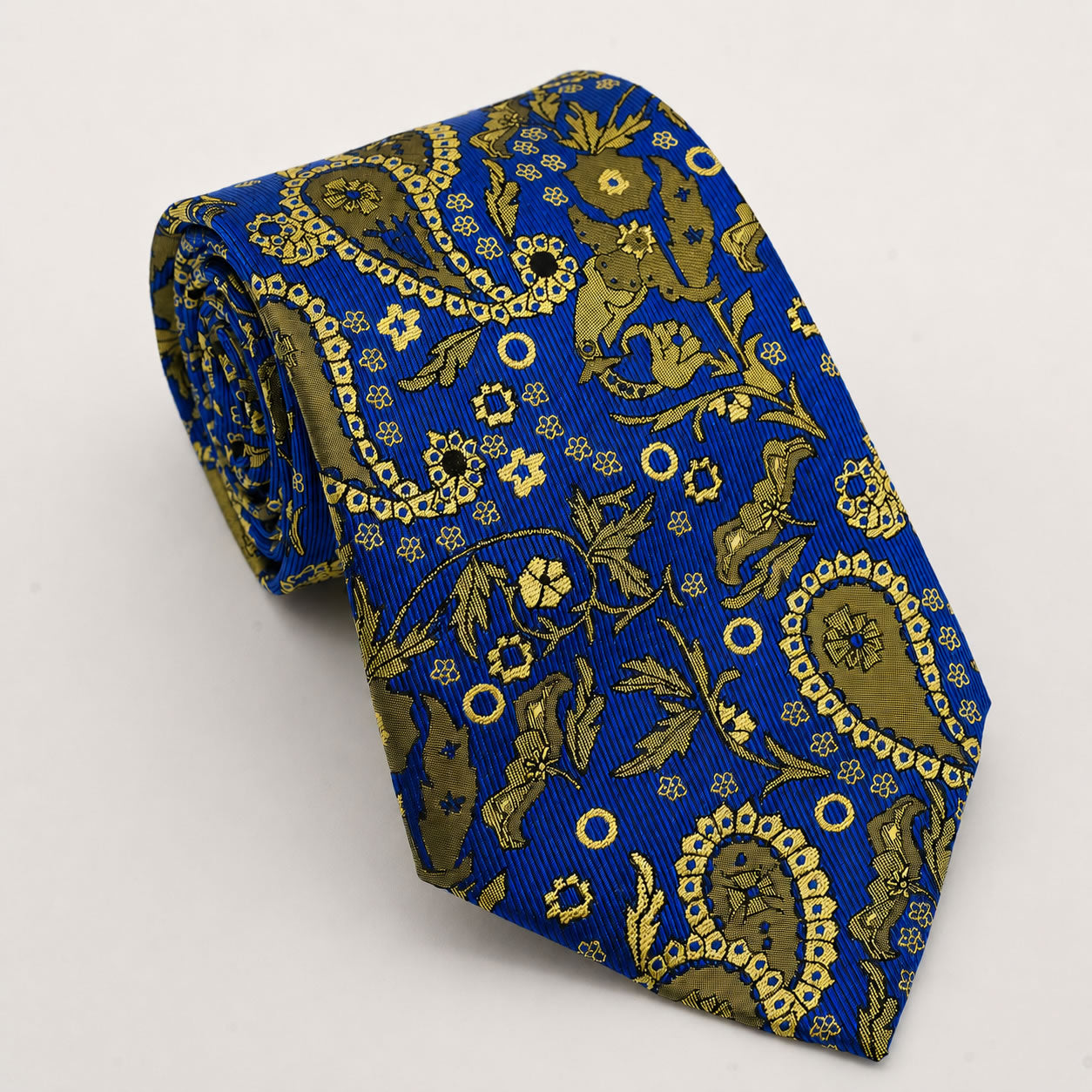 A rolled George Neale royal blue and gold paisley silk tie.
