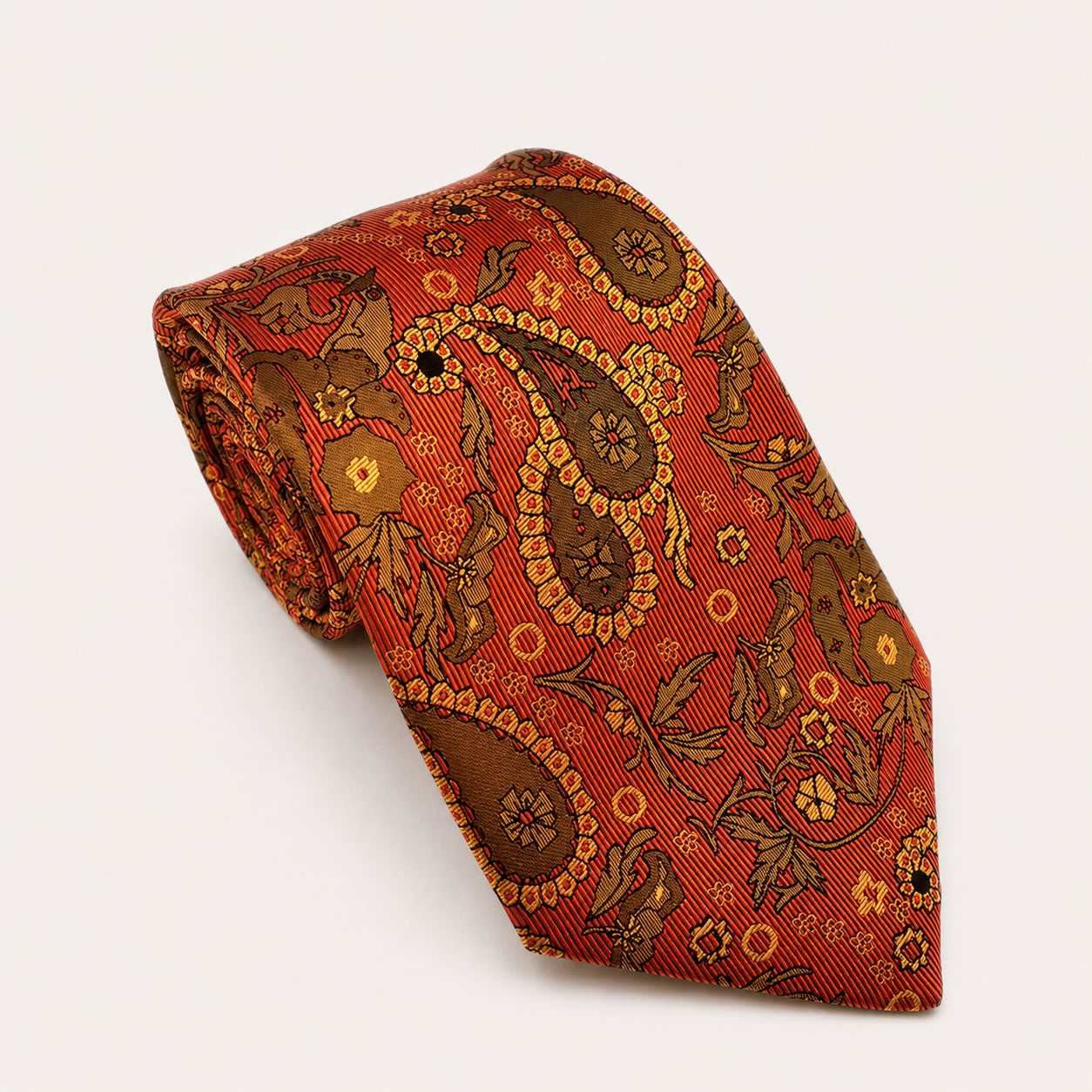 A rolled George Neale orange and brown paisley silk tie.