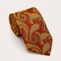 A rolled George Neale burnt orange and gold paisley silk tie.