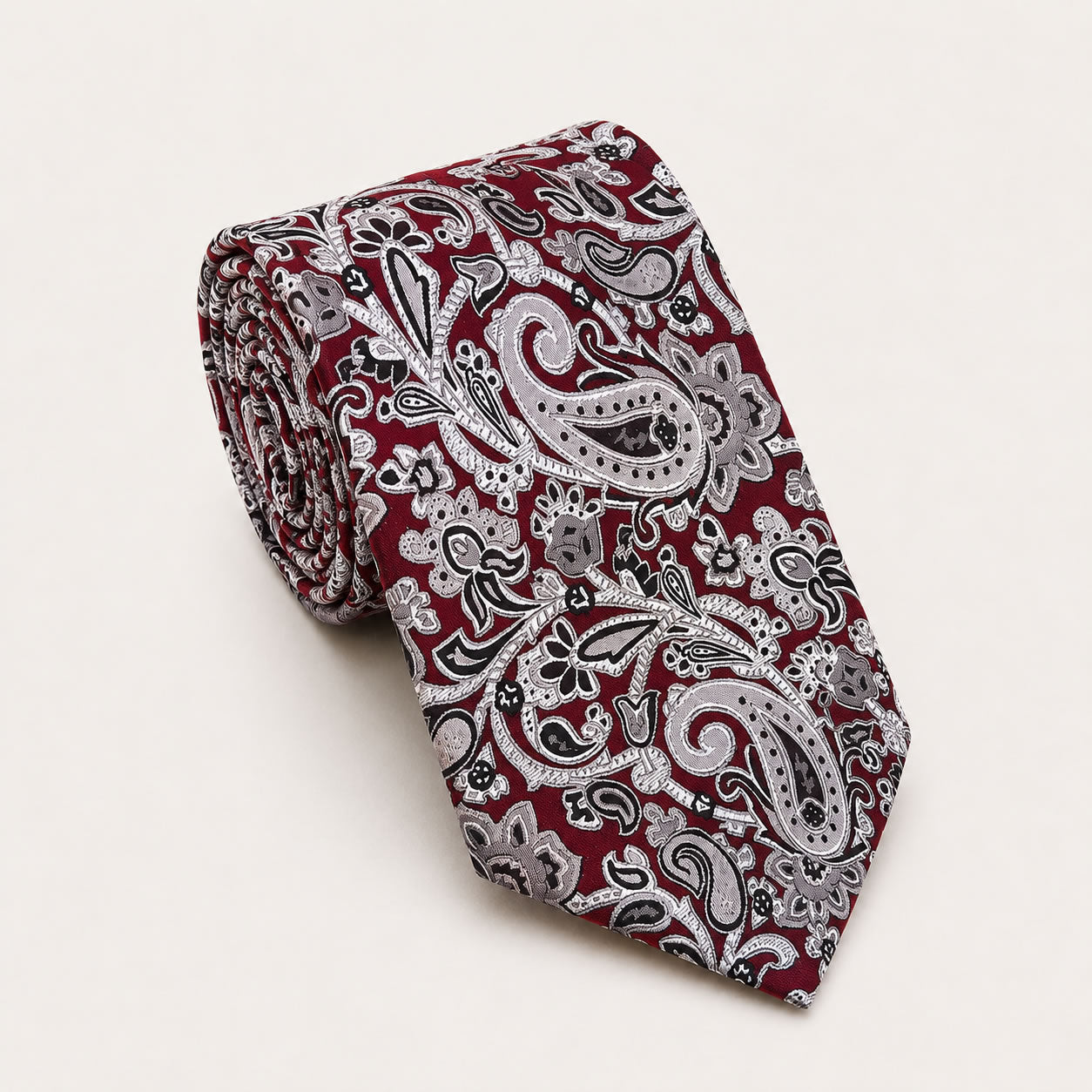 A rolled George Neale maroon and silver paisley silk tie.