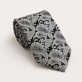 A rolled George Neale black and silver paisley silk tie.