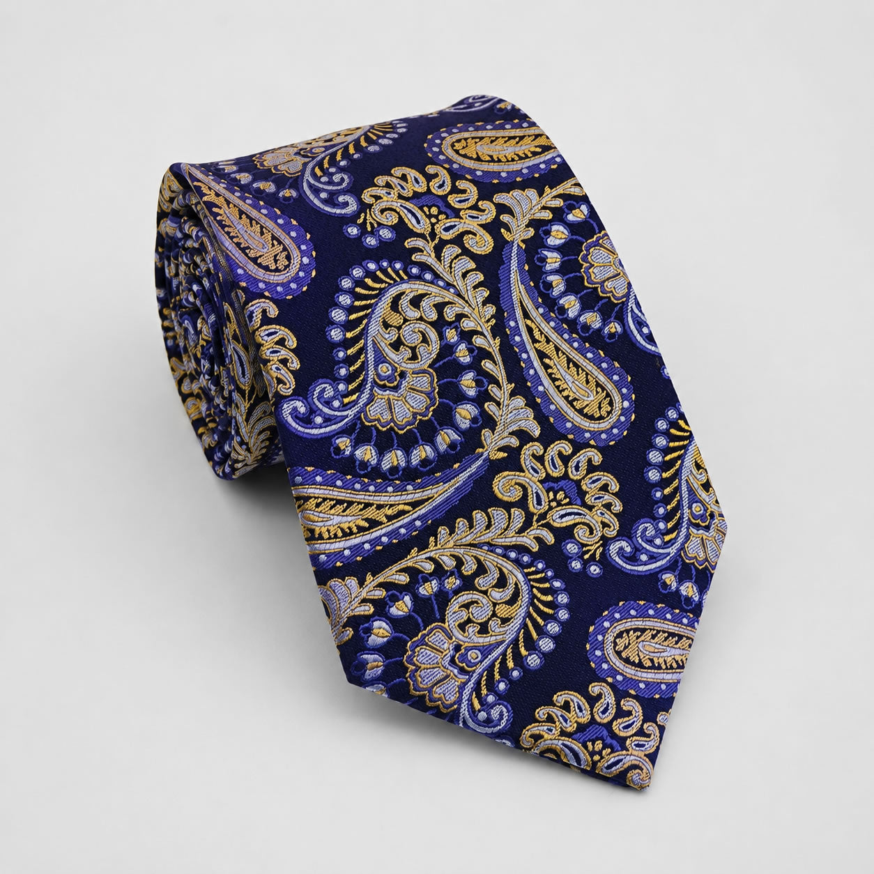 A rolled George Neale navy and gold paisley silk tie.