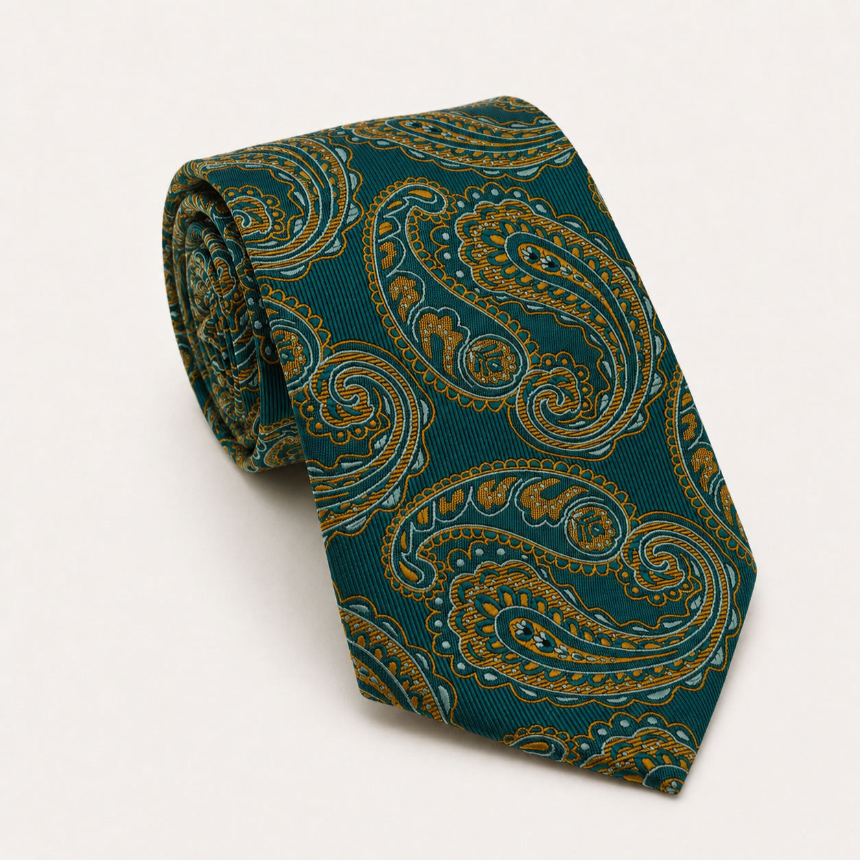 A rolled George Neale green and gold paisley silk tie.