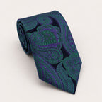 A rolled George Neale dark blue and green paisley silk tie.