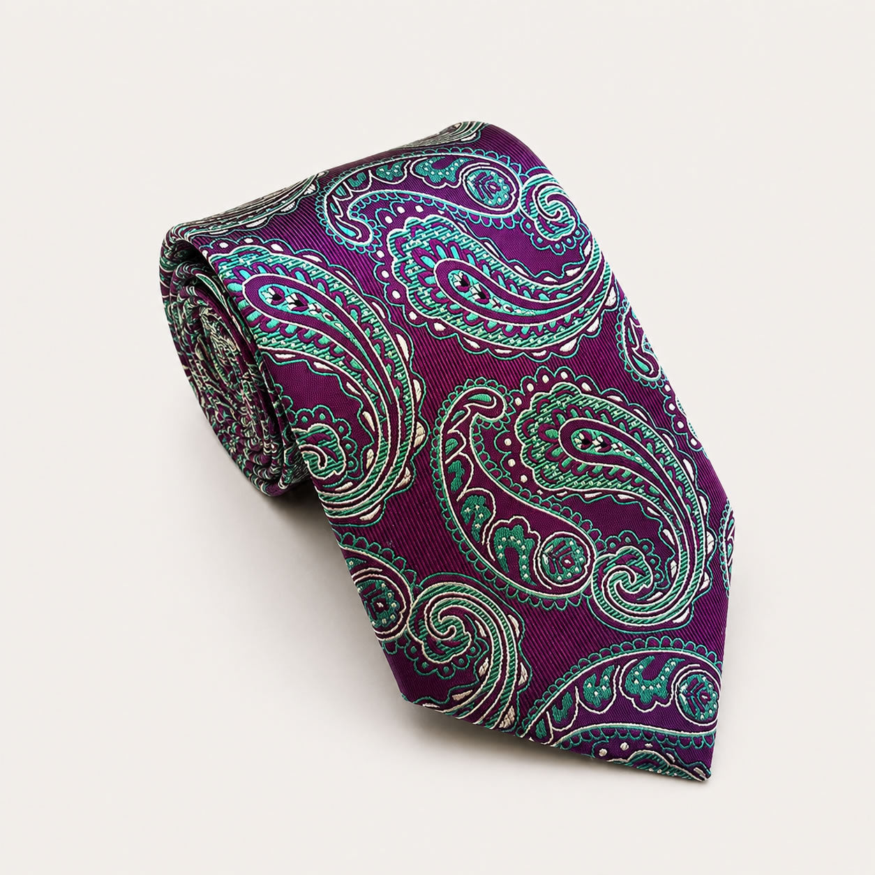 A rolled George Neale purple and teal paisley silk tie.