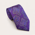 A rolled George Neale purple and blue paisley silk tie.