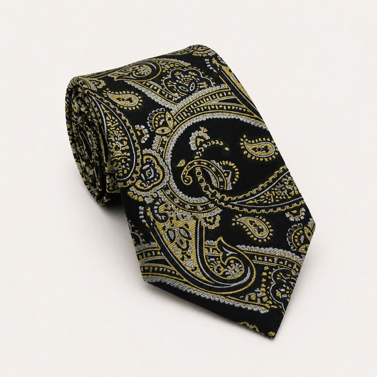 A rolled George Neale black and gold paisley silk tie.