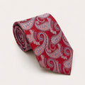 A rolled George Neale red and salmon paisley silk tie.