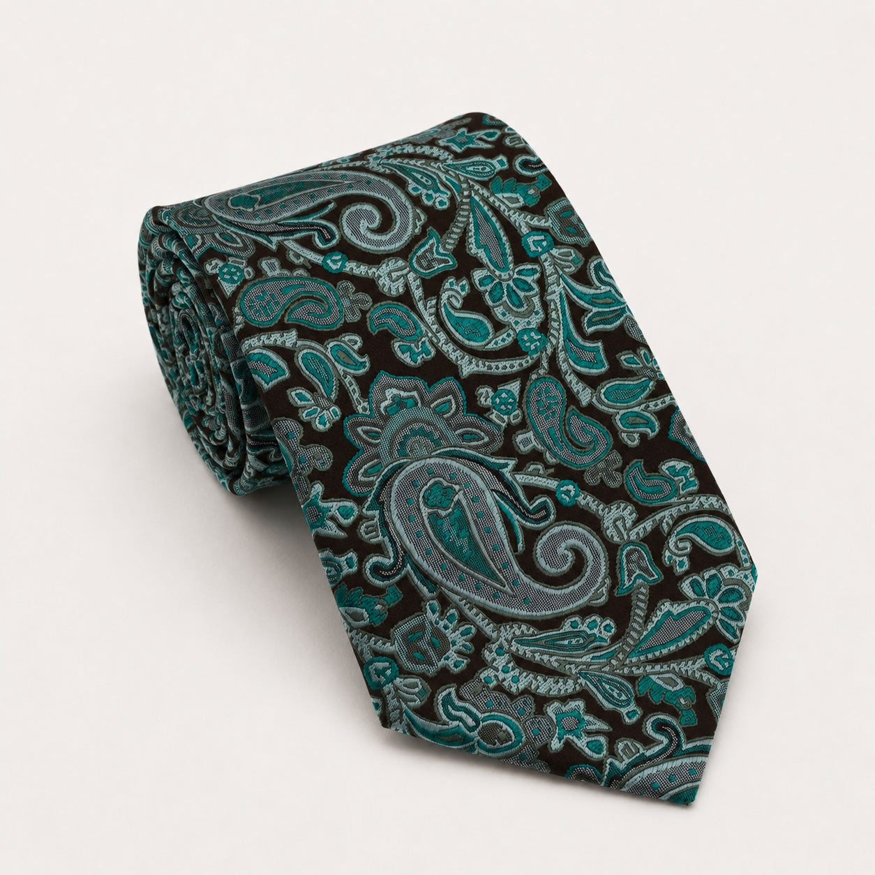 A rolled George Neale black and deep teal paisley silk tie.