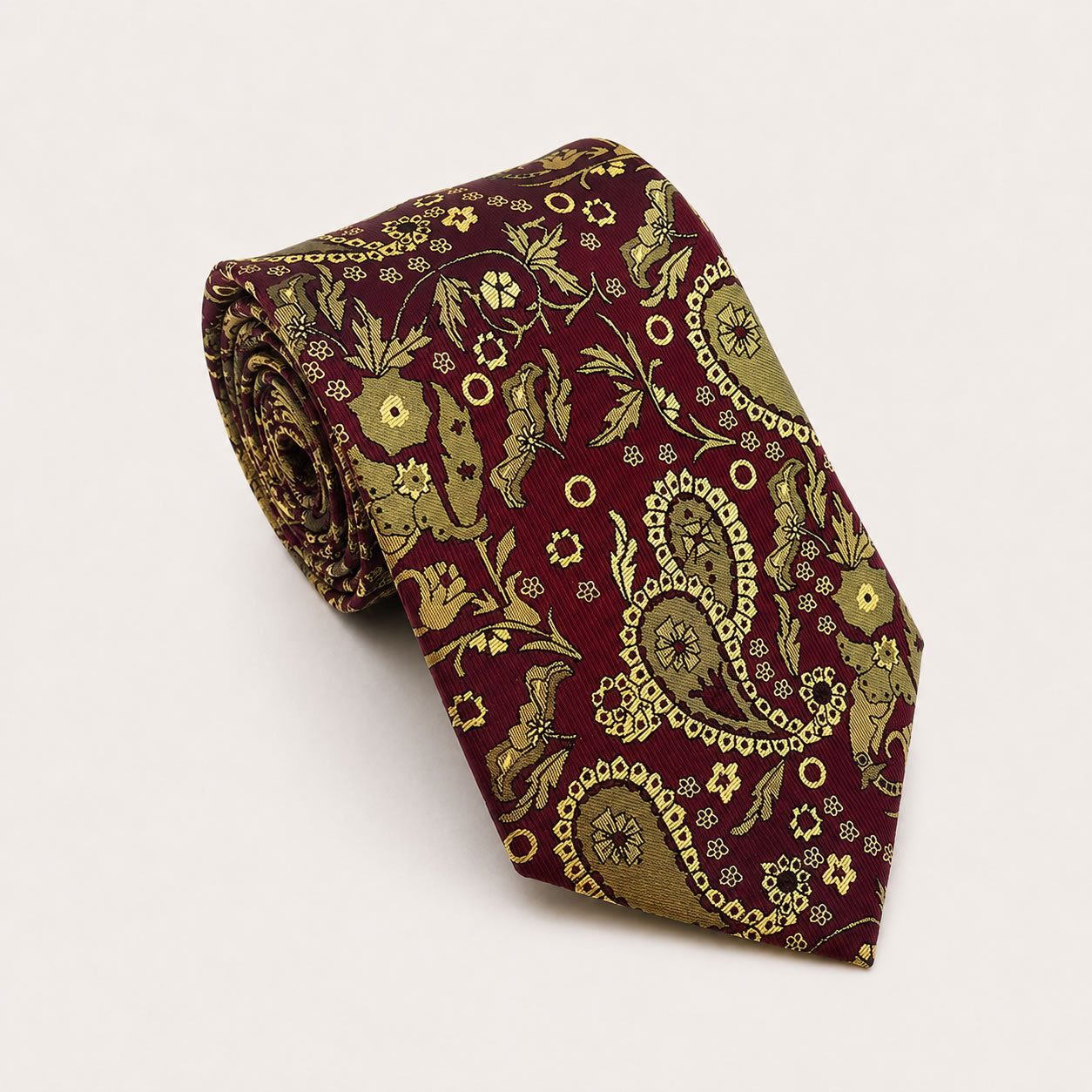 A rolled George Neale burgundy and gold paisley silk tie.