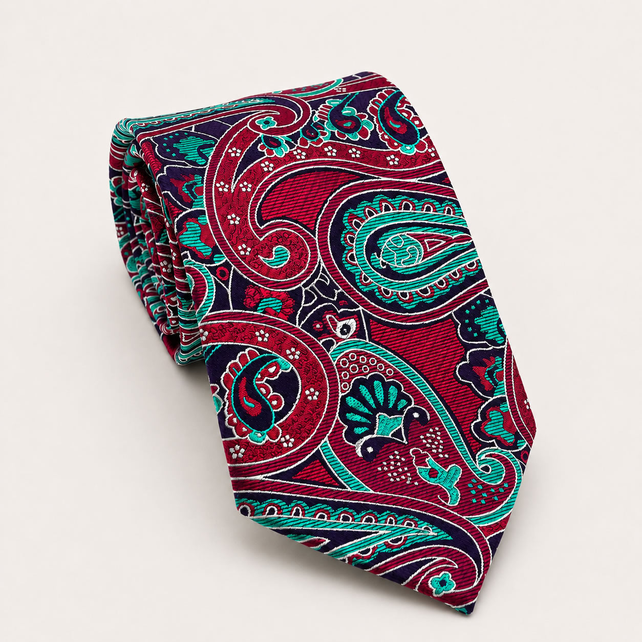 A rolled George Neale crimson and teal paisley silk tie.