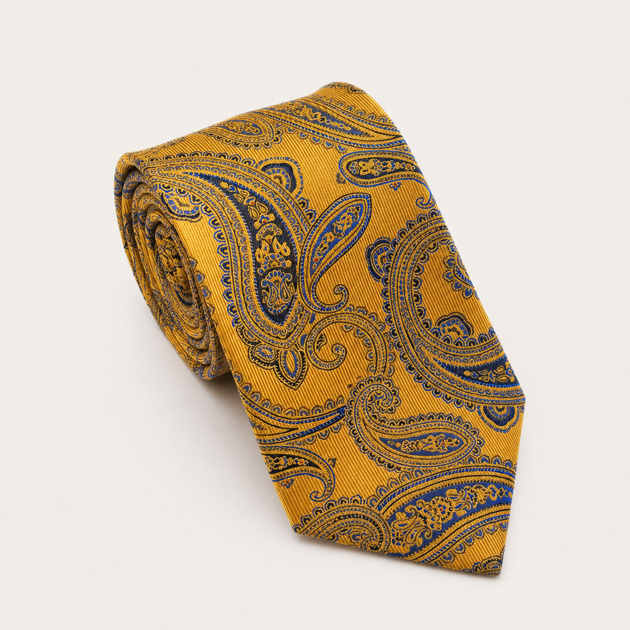 A rolled George Neale gold and navy paisley silk tie.
