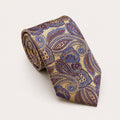 A rolled George Neale champagne and blue paisley silk tie.
