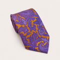 A rolled George Neale purple and gold paisley silk tie.