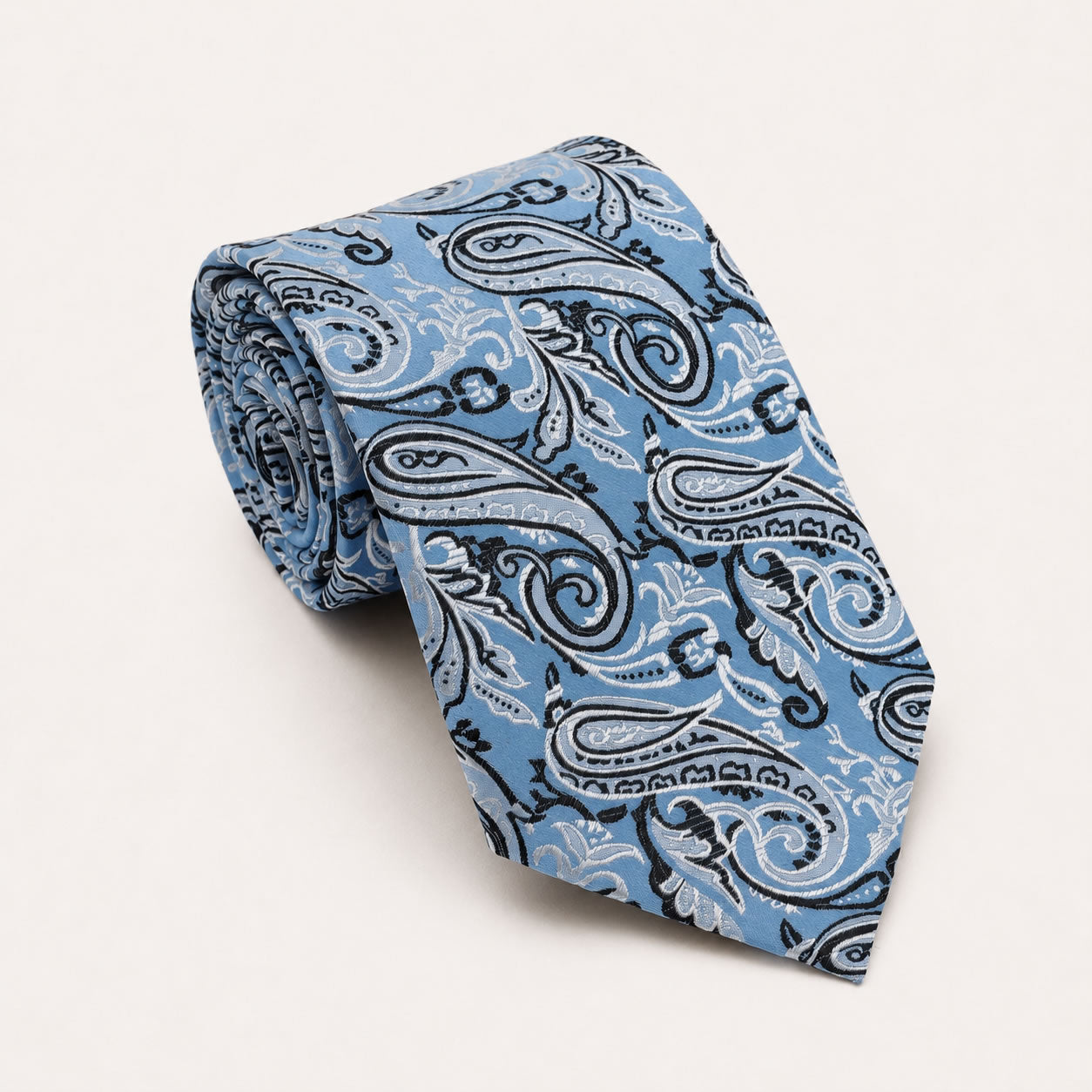 A rolled George Neale light blue and black paisley silk tie.