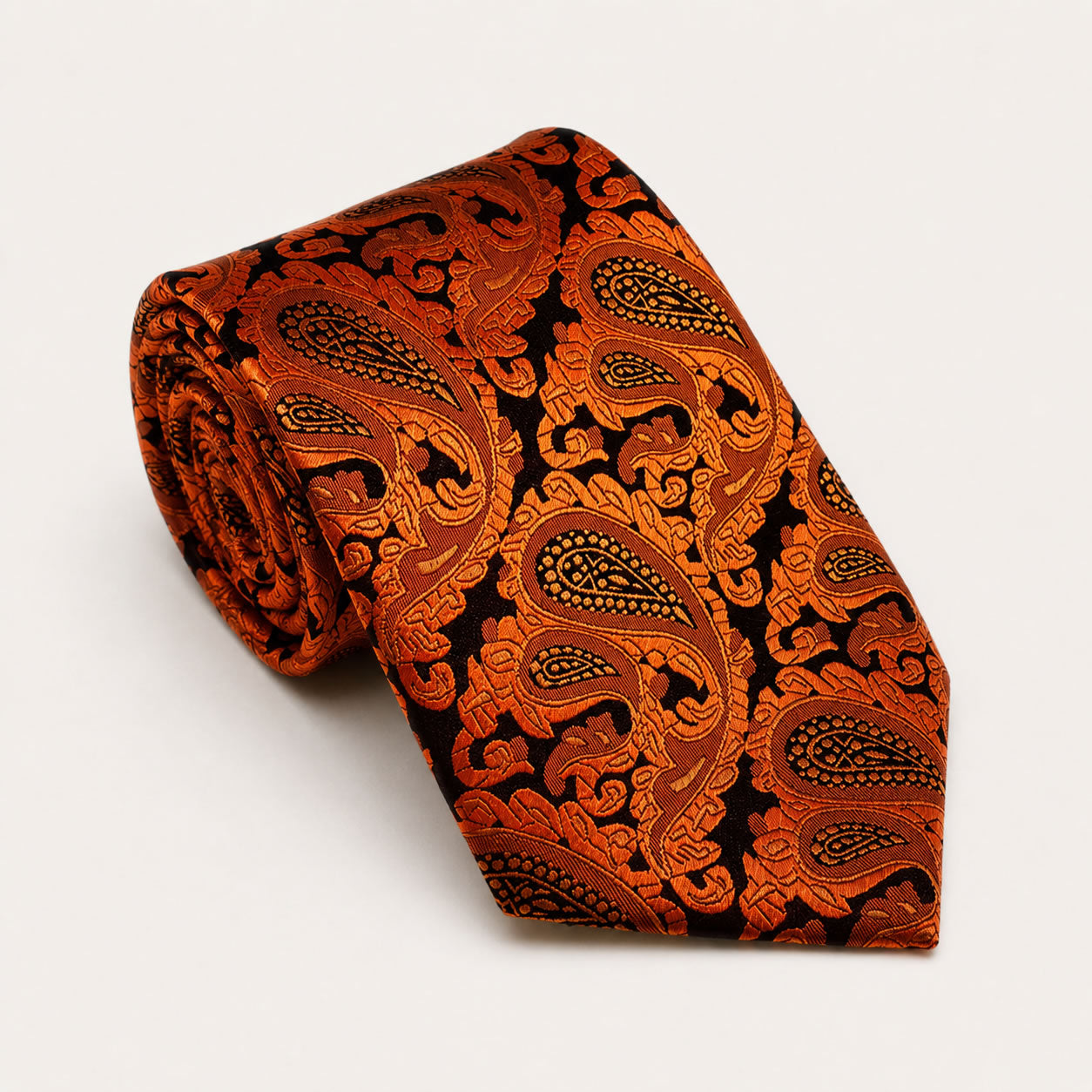 A rolled George Neale orange and black paisley silk tie.
